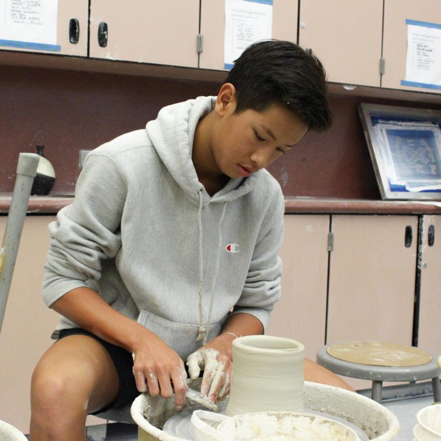 POTTER(L)Y IN LOVE: Autumn is junior Kenneth Duong’s favorite time for wheel throwing in ceramics class.