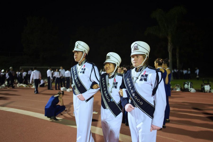 BAND TEN HUT: (left to right) Sepulveda, Fujimori and Miller prepare to call Marching Band to order.