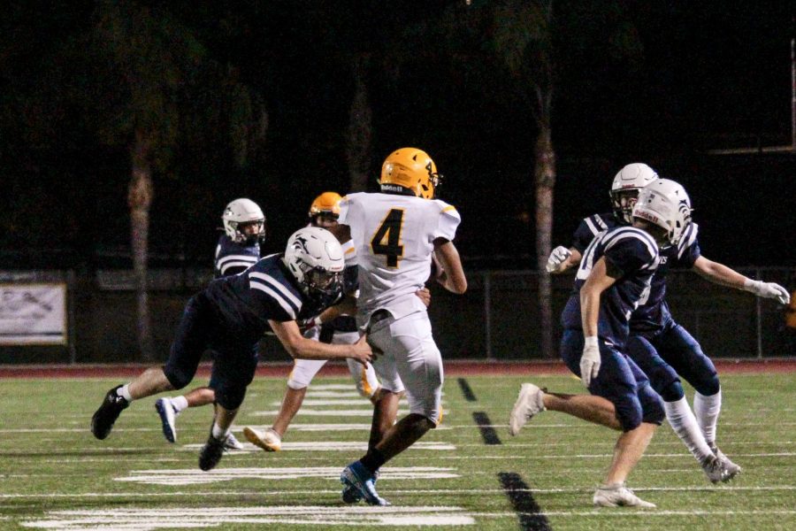 DOING WHATEVER IT TAKES: Freshman Andrew Penrod secures a tackle to avoid a big gain on the ground.