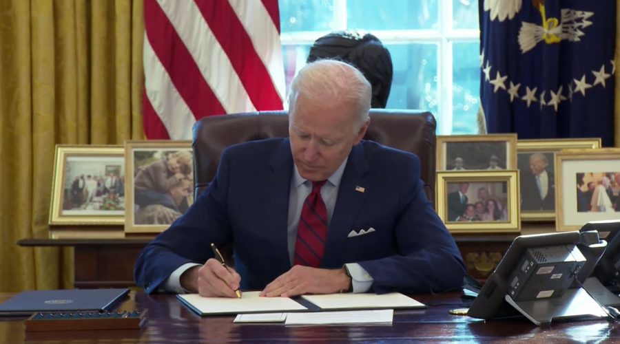 Signature move: President Biden signs one of the many executive orders in the early days of his presidency.