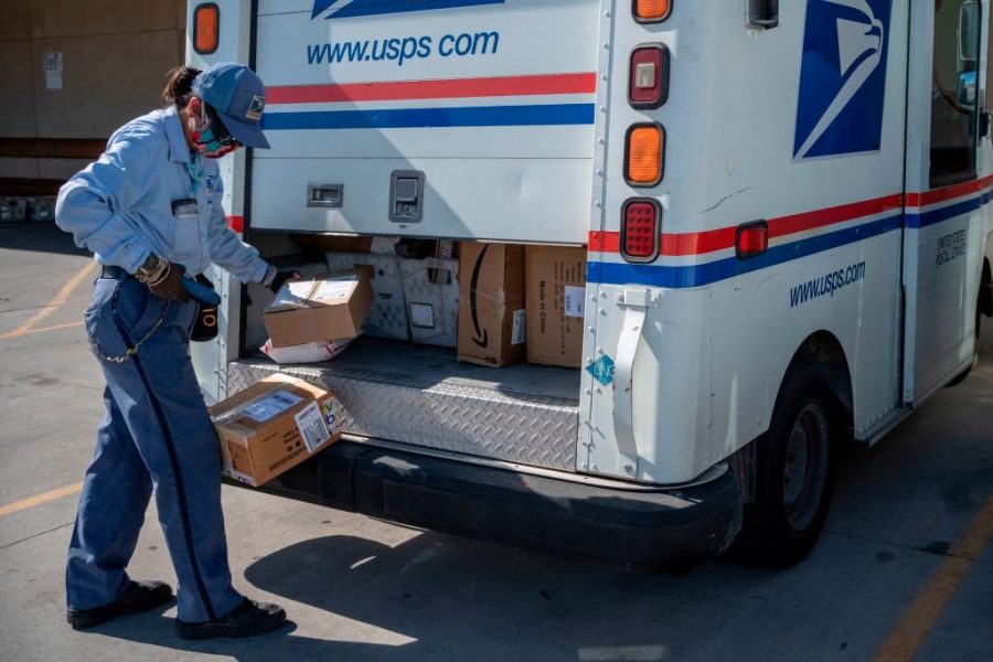 DELIVERING FOR AMERICA: A USPS driver delivers packages in the early months of the COVID-19 pandemic.
