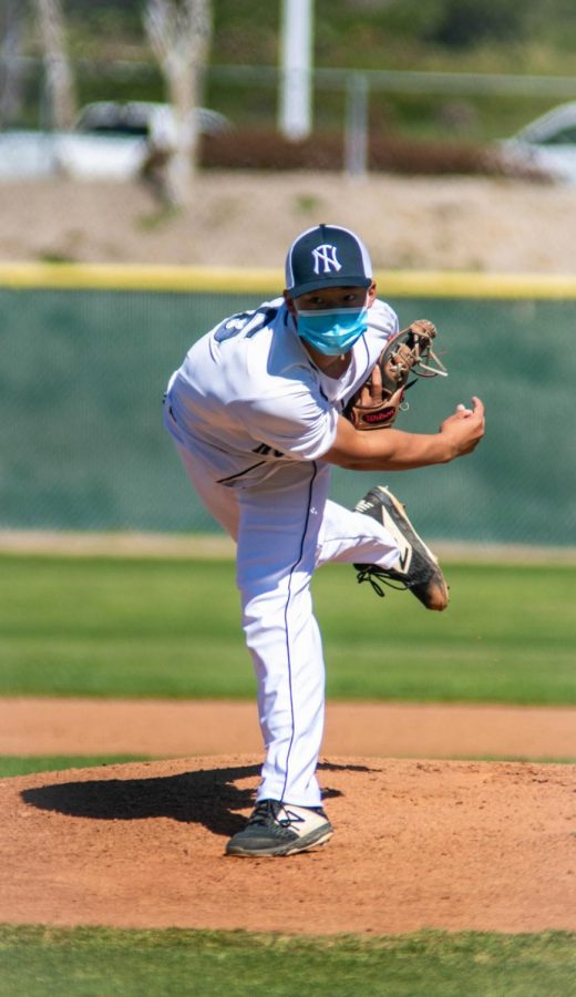 STRIKE-OUT: Junior Ethan Chen pitches a heater to a batter.