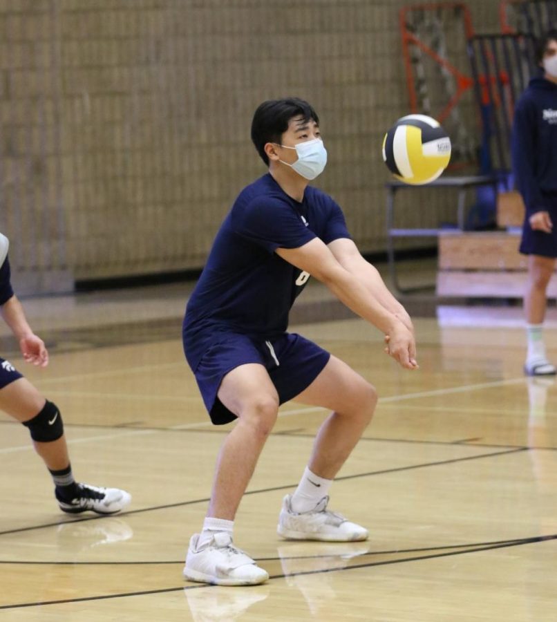 DEFENDING SKILLFULLY: Junior Harry Kim swiftly receives a serve.