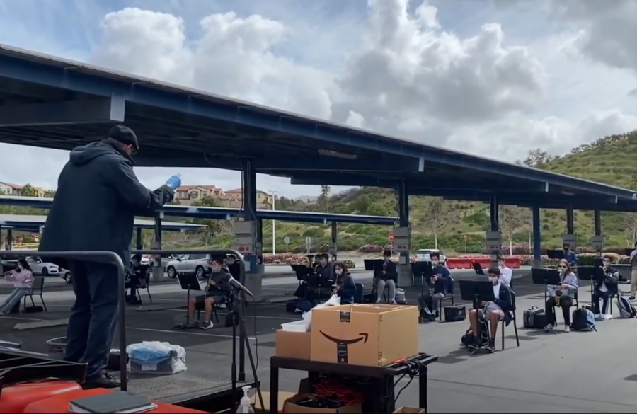 BRINGING HARMONY: Wind Symphony performs their piece “Courage” in windy weather, six feet apart.