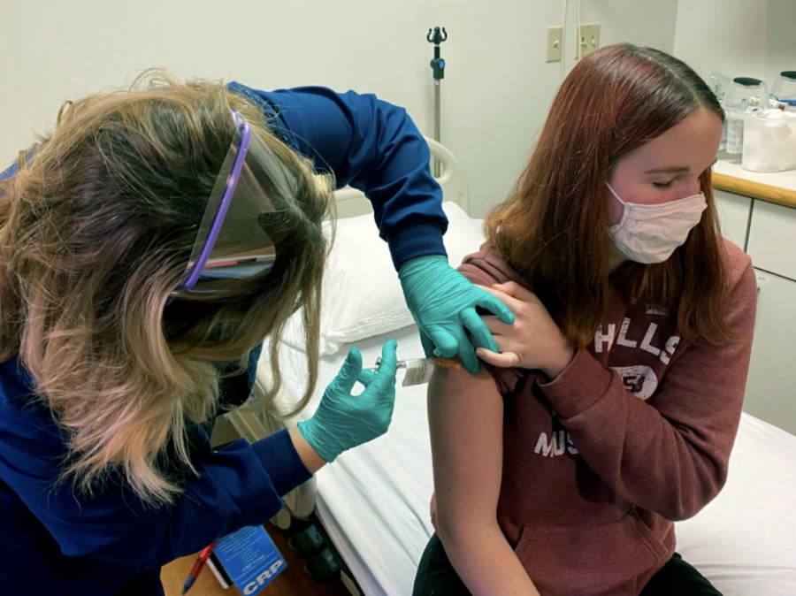 A high school junior receives the Pfizer and BioNTech COVID-19 vaccine as part of a clinical trial.