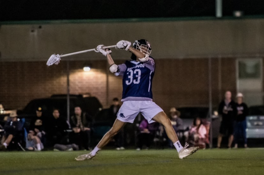 BORN TO LAX: Senior Ethan Koers propels the ball to a teammate as the long-stick midfielder in a game against Edison High School. 