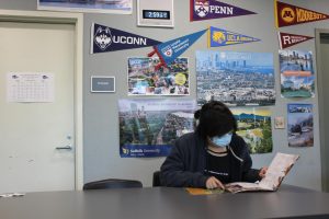 FINDING THE RIGHT FIT: Sophomore Julien Valladares studies a college brochure as they search for a school matching their interests.