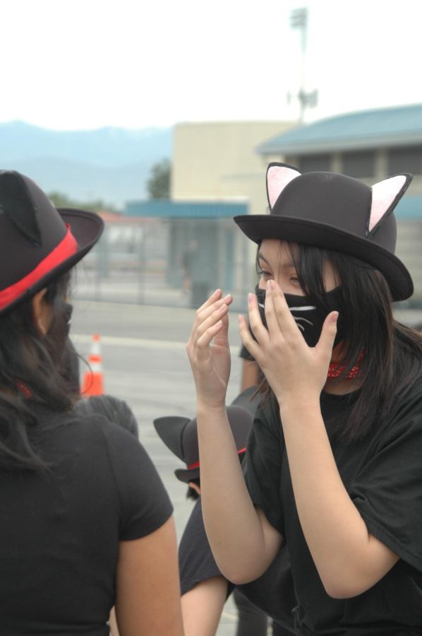 DON’T LET YOUR GUARD DOWN: Freshman Caitlyn Tran excitedly talks to sophomore Anika Aloni in their cat costumes.