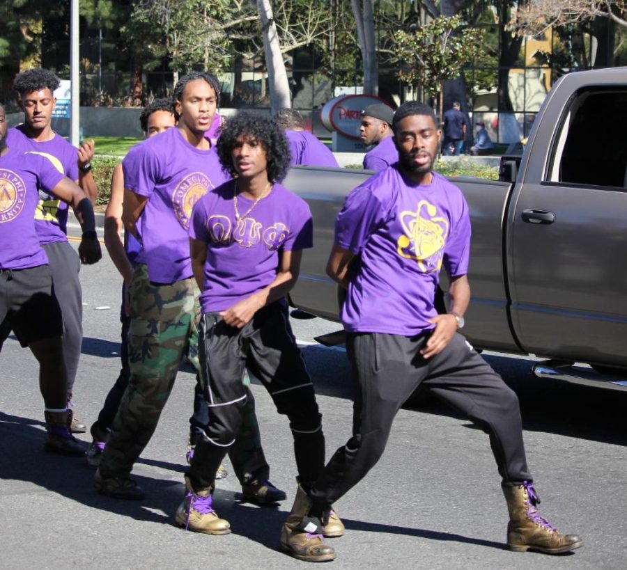 PARADING THE STREETS: Members of local fraternities were part of the motorcade that included antique cars and leaders in the Black community, from state senators to kickboxing champions. 