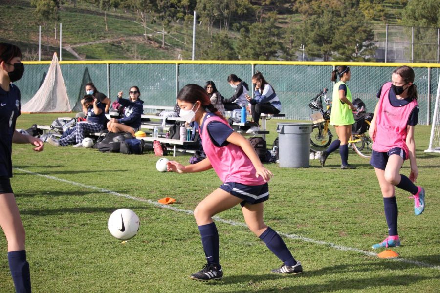 READY TO RUN: Freshman Riley Thai sprints towards the soccer ball, scanning the field to determine whether to dribble the ball or pass it to her teammate during a practice scrimmage. 