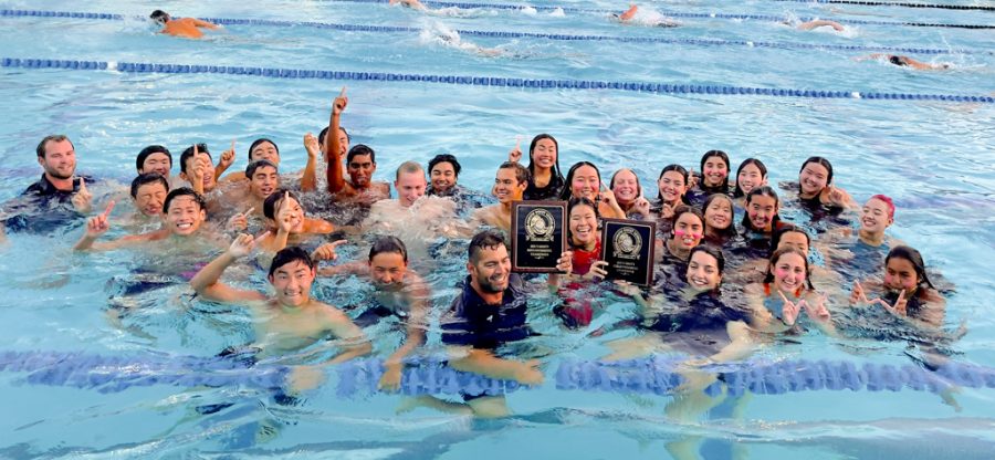 Frenzy+of+Firsts%3A+Northwood%E2%80%99s+swim+team+takes+a+triumphant+plunge+and+holds+up+number+one+hand+signs+to+celebrate+their+first+time+winning+first+place+at+the+Pacific+Coast+League+Finals.%0A