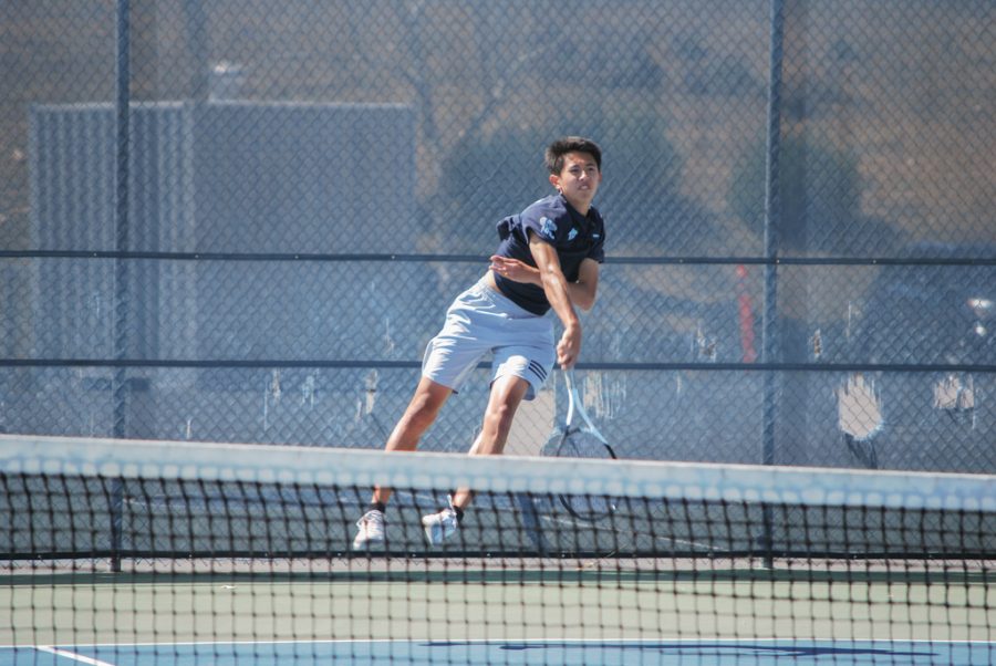 Senior Spencer Ho jumps to return the ball to the other side of the court during the CIF-SS match against Servite High School. 