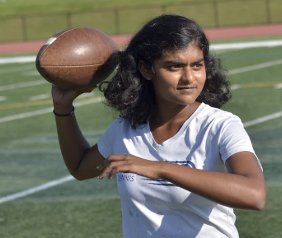 REFUSE TO LOSE: Sophomore Keerthana Venkateswaran passes a football with freshman Yasmine Anan before tennis practice. 
