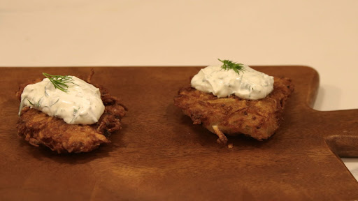 These crispy, pan-fried potato pancakes are a classic Jewish meal eaten around Hanukkah. They are made from grated potato and onion, binded together with an egg and matzo meal and served with sour cream on top. 