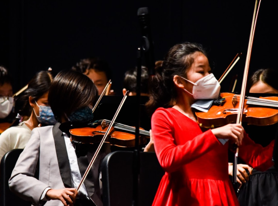 Elementary school violinists passionately execute their melody during “A Festival Rondo” amongst other performers from the Northwood area.