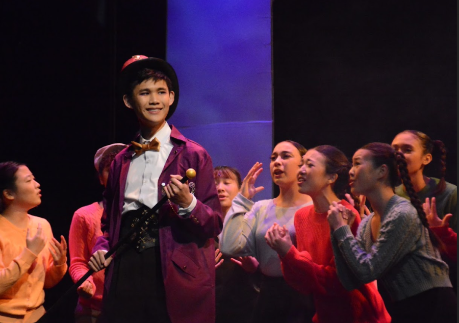 A SWEET SURPRISE: Willy Wonka lead senior Ze Xi Isaac Lee and the rest of the cast opens the night with their inviting performance of “The Golden Age of Chocolate.”