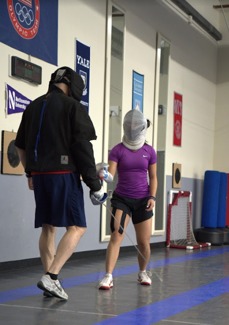 GIVE, BUT DON’T RECIEVE: Madeline Huang works with her coach, perfecting her fencing techniques to prepare for the Junior Olympics.