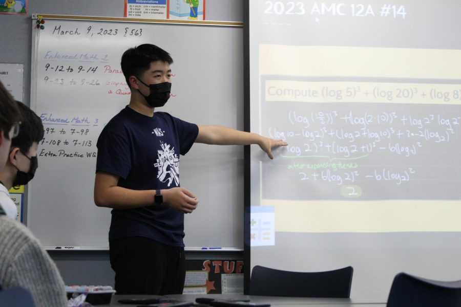SOLVING PROBLEMS, ONE EQUATION AT A TIME: Junior William Deng teaches members of Math Olympiad how to compute log equations.