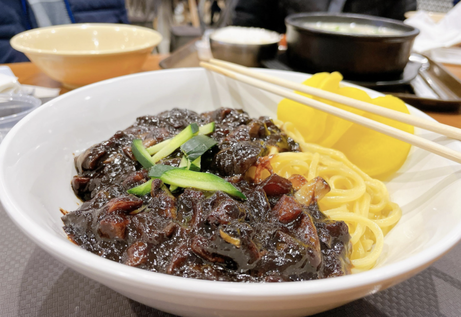 JJAJIANGMYEON: The black soybean noodle comes with a side of yellow pickled radishes. 
