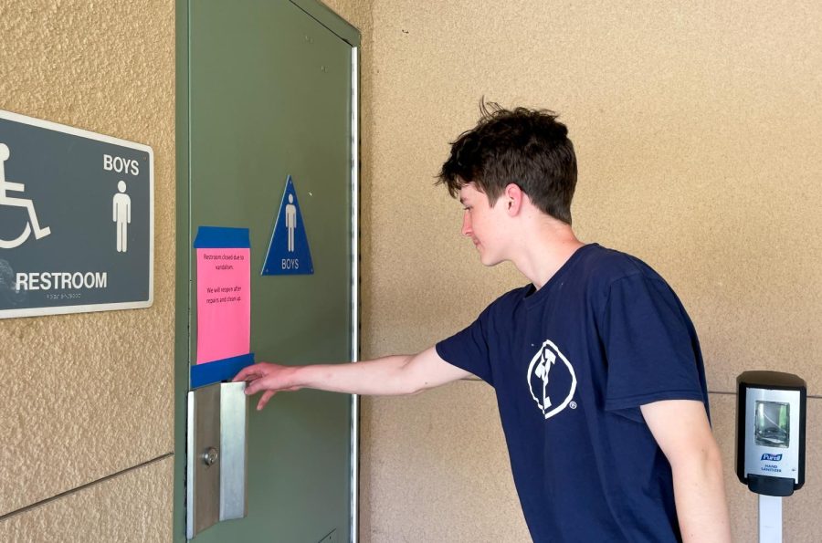 A STICKY SITUATION: Hand sanitizers left outside the bathrooms can be used as a substitute for soap until vandalism comes to an end, as seen right of sophomore Hunter Welch.