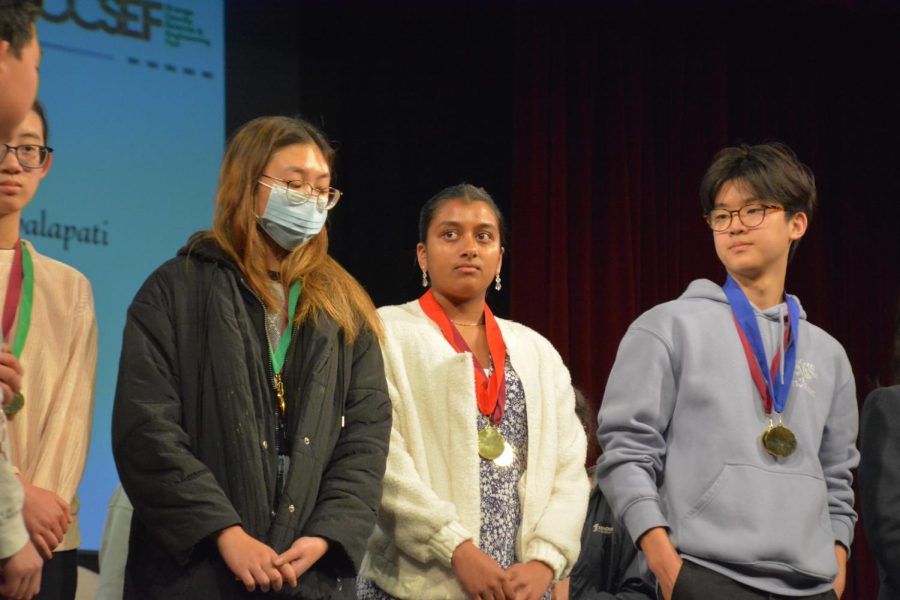 SCIENCE MATTERS: Sophomore Anika Bhat (middle) collects her medal at Chapman University after advancing to the state level 
competition, winning second place in the Physiology/Medical division of OCSEF for her investigative science project. 