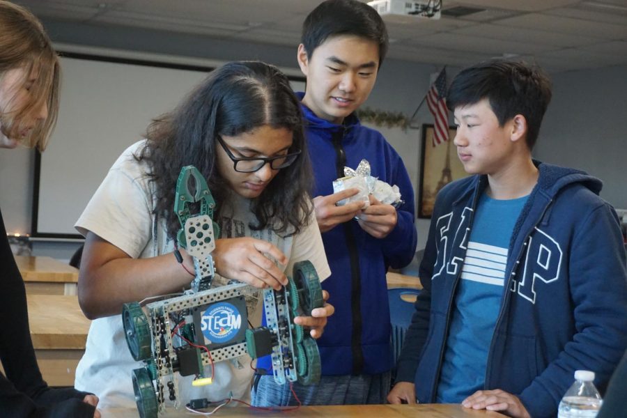 RADIANT ROBOTICS:  Freshman Jia Dave demonstrates the correct way to construct a VEX robotics build to club observers, prospective members and competitors. 
