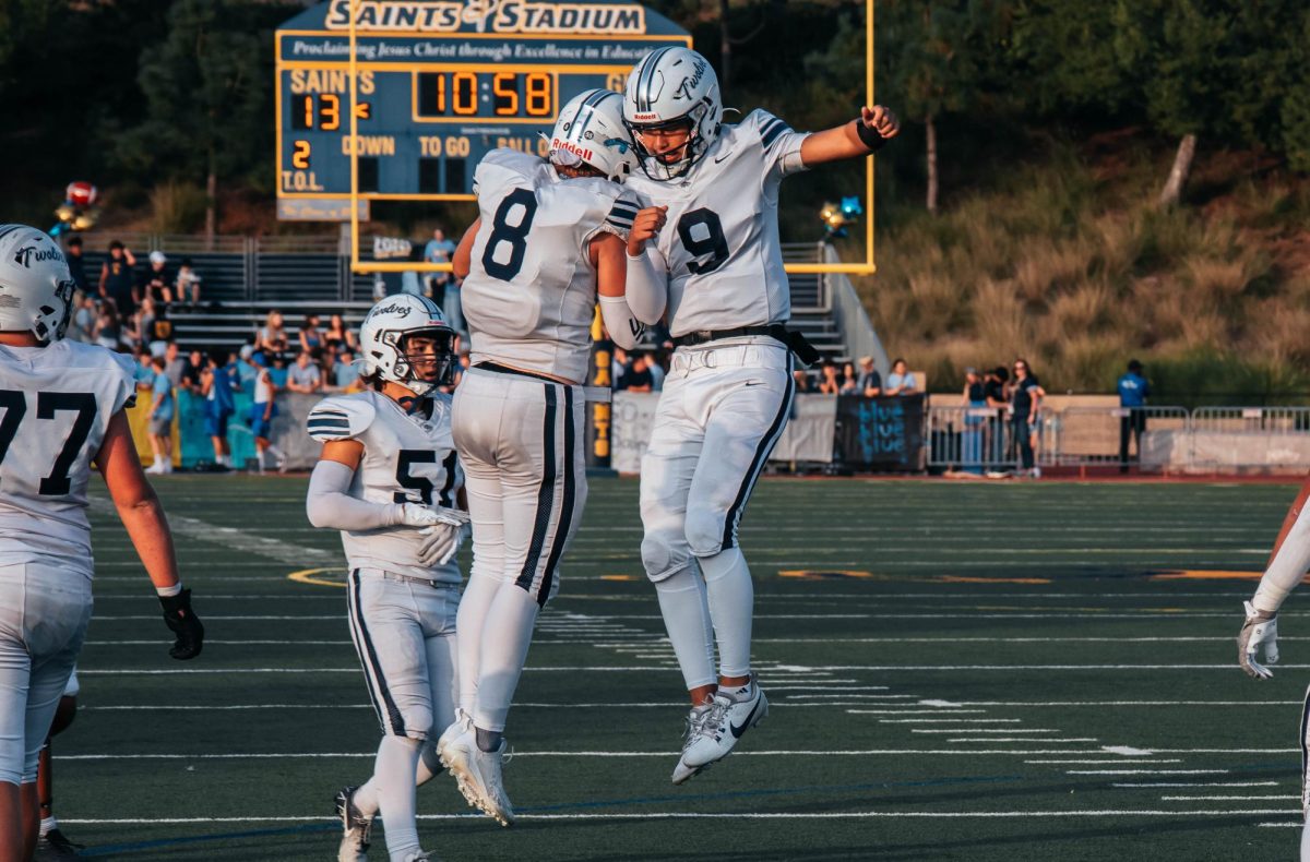 CELEBRATING CONNECTIONS: Quarterback senior Eddie Ma and junior Joseph Harper celebrate after a completed pass between the two.
