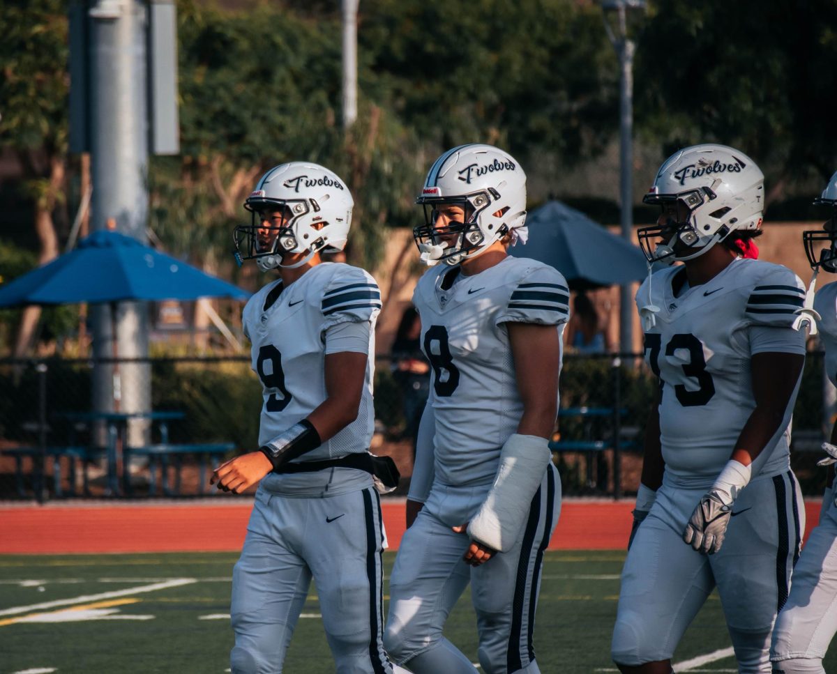 READY FOR A COMEBACK: Senior Eddie Ma, junior Joseph Harper and junior Tao Sun lead their team back out to the field after half time.