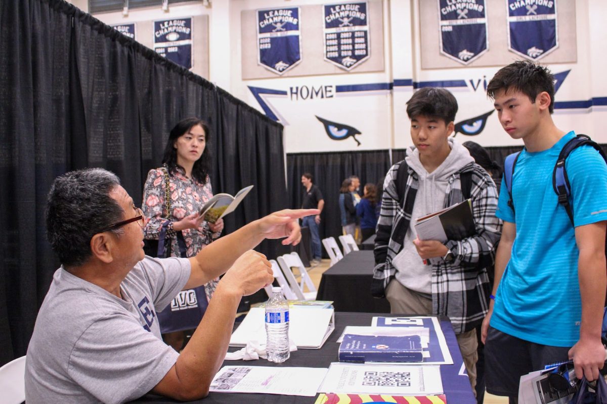 PREPARING A PATHWAY: Freshmen Alex Li and Anderson Lay discuss with the Yale college representative about extracurricular activities to pursue.