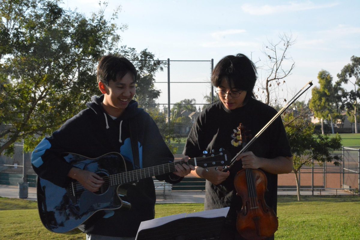 PRACTICE MAKES PERFECT: Senior Samuel Vo and junior Allen Wen practice holiday tunes.