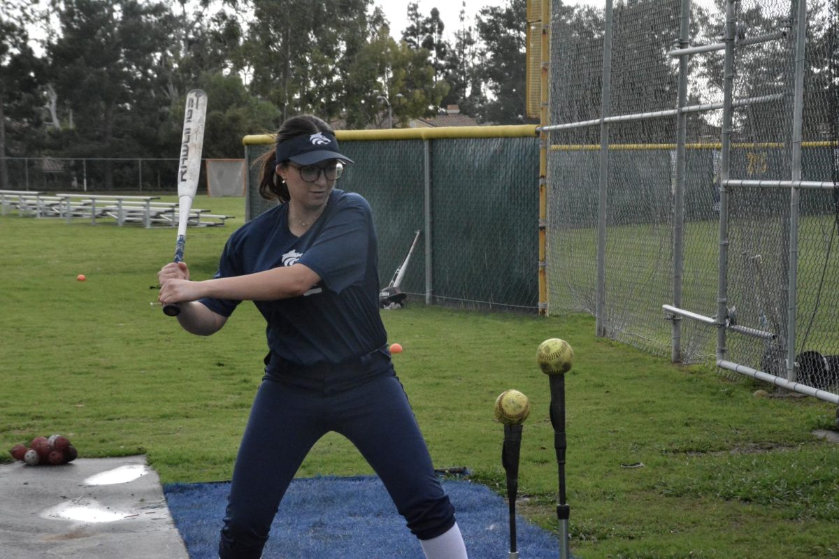 FINDING BALANCE: Junior Ines Khodja continues to practice her softball swing during practice even through Ramadan fasting.