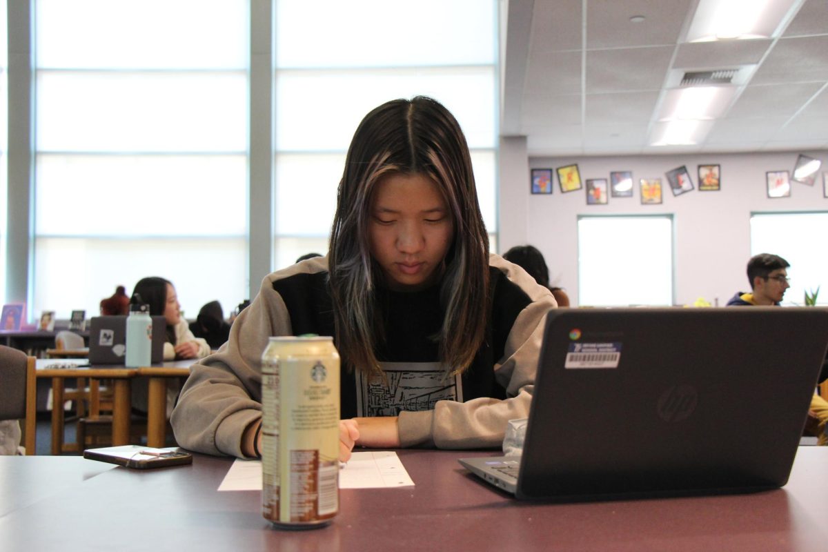 ADDICTING ENERGY: Junior Gabby Lan continues to study with the help of an energy drink.