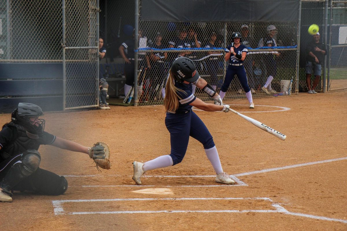 BATTER UP: Senior Mia Fogle winds up to hit the ball out of the park.
