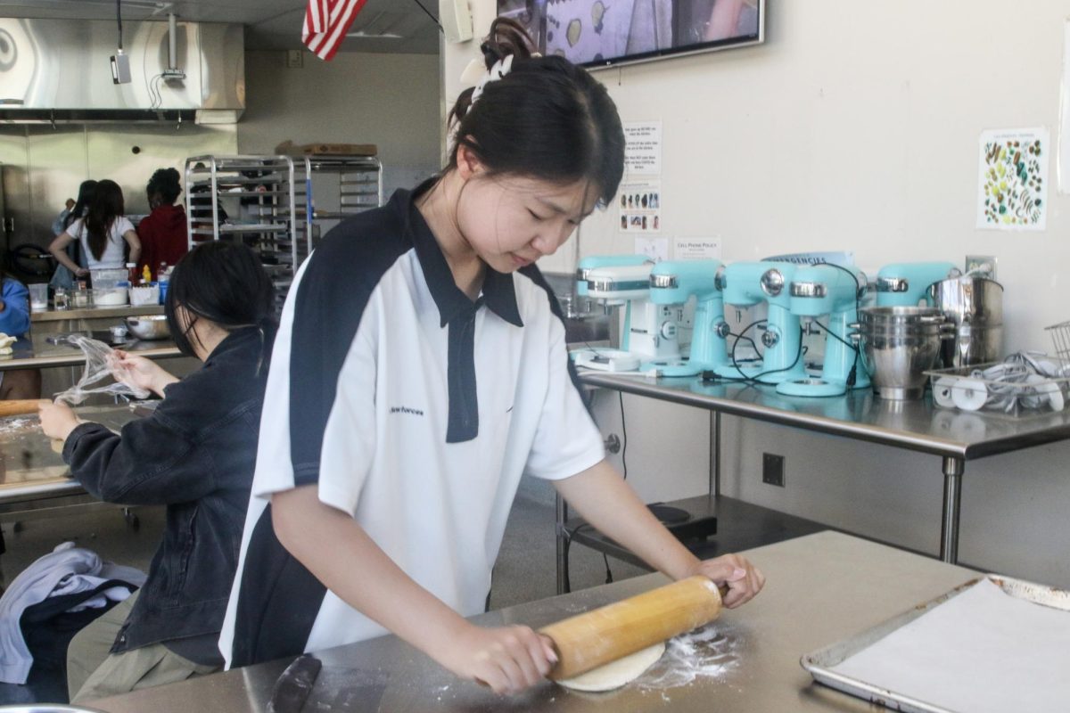 LET THEM COOK: Sophomore Ellie Ji practices the skills she learned in culinary class to bake a class recipe.