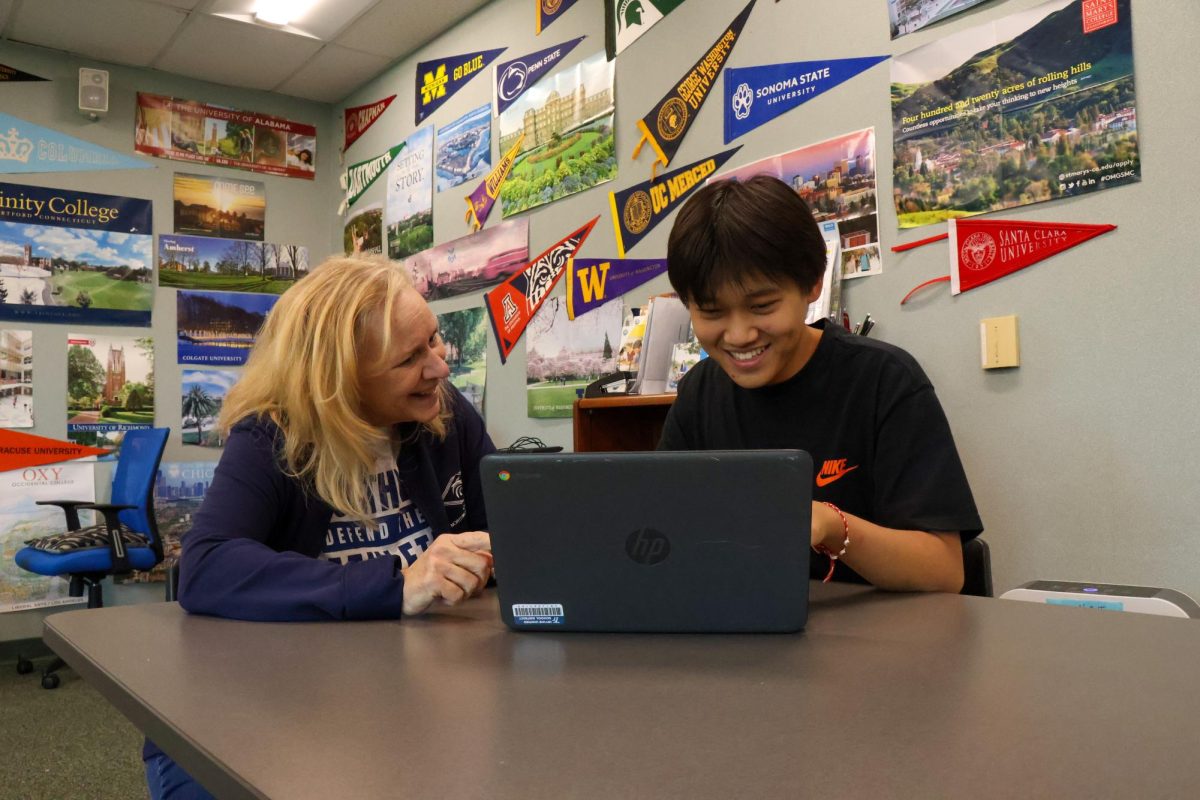 Navigating new Routes: College and Career Specialist Kathi Smith helps senior Vincent Yang with the CaliforniaColleges website.