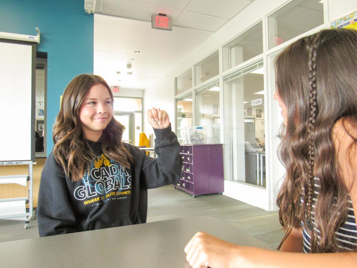 LEARNING THE BASICS: Freshman Paige Volpe practices signing the ASL alphabet with her partner during class. As with verbal languages, mastering the alphabet is a critical first step toward engaging in more challenging, personal conversations.