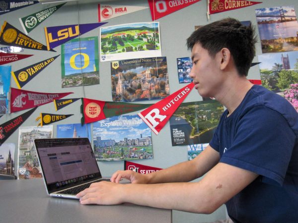 APPROACHING APPLICATIONS: Senior Stanley Suen works on his Common App in the college and career center after school.