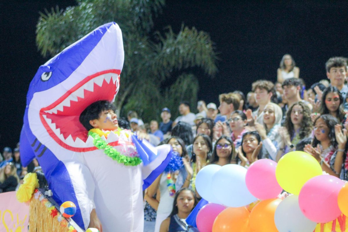 HARK ATTACK: Spirit and Rally Commissioner junior Nathan How attacks the new school year, re-energizing Northwood’s student section at the Beach Bash football game by leading cheers and chants.