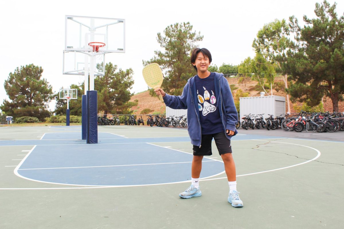 PICKLEBALL PLAY: Freshman Leo Liu practices his skills on the basketball court in preparation for the new lines to be painted in.
