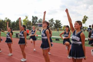 GAME DAY ENERGY: Northwood’s JV Pep Squad kicks off the home game by energizing the frosh football team from the sidelines. 