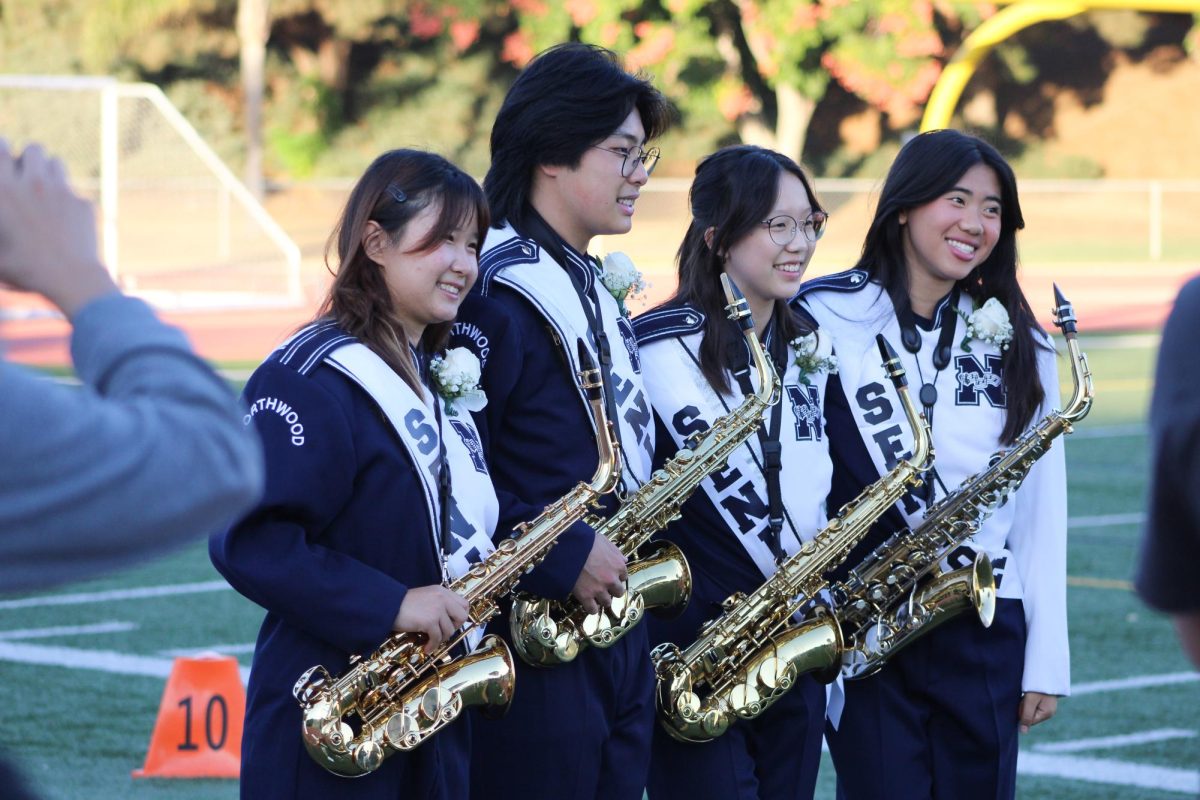 ENDING ON A HIGH NOTE: Seniors Jessica Li, Allen Wen, Ellie Guo and Elise Kong take their senior photos before the game. 