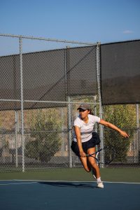 A WONG-DERFUL WIN: In a doubles match against Sage Hill School, varsity tennis captain senior Baylie Wong volleys the ball back to her opponents during the girls’ tennis senior night.