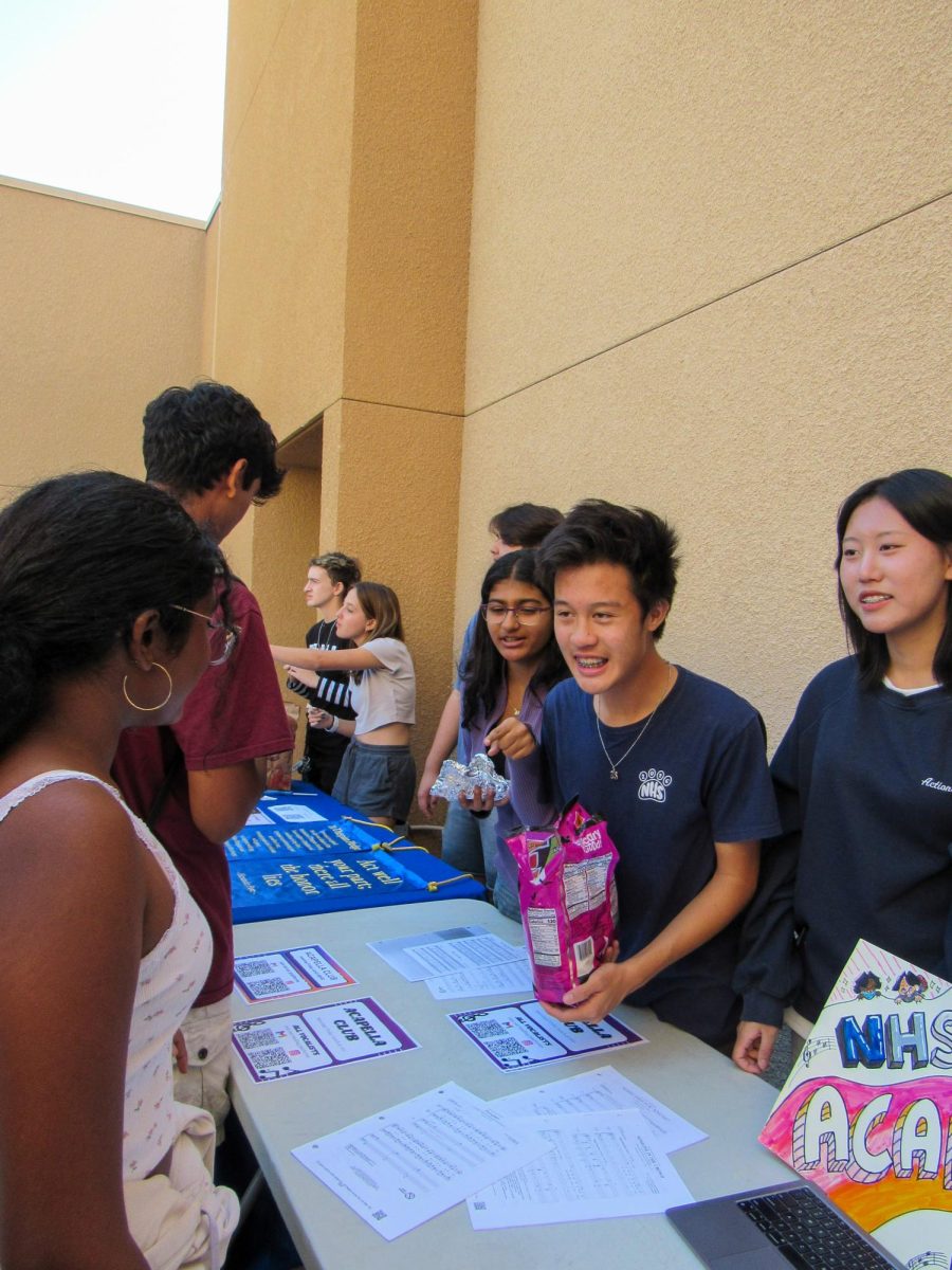 SINGING STARS: The Acapella Club passes out candy and fliers during Club Rush. 
