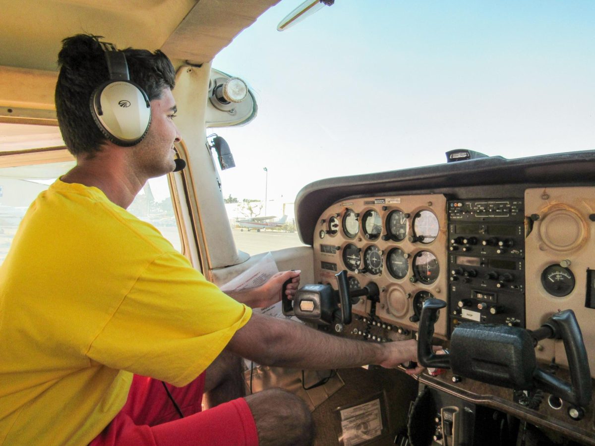 IT'S A BIRD, IT'S A PLANE, IT'S VIRAJ: Senior Viraj Kadakia toggles with the controls in an airplane before his flying class starts. He is practicing his take-offs and landings in preparation for his pilot's license examination in November.