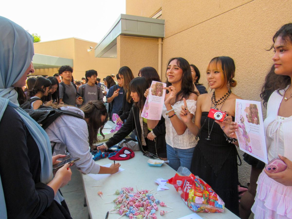 SELF-EXPRESSION IS IN STYLE: During club rush, senior fashion club president Dae Truong and other members pass out fliers and candy to students, telling them about the club's agenda and mission in order to advertise their club. 