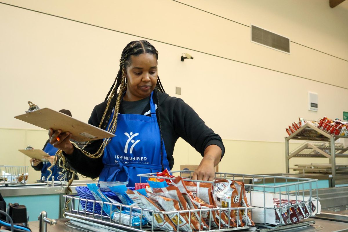 READY FOR LUNCH: Nutritional services associate II Cesily Hadley takes inventory of the leftovers from the morning break before clearing them out in preparation for the lunch rush.