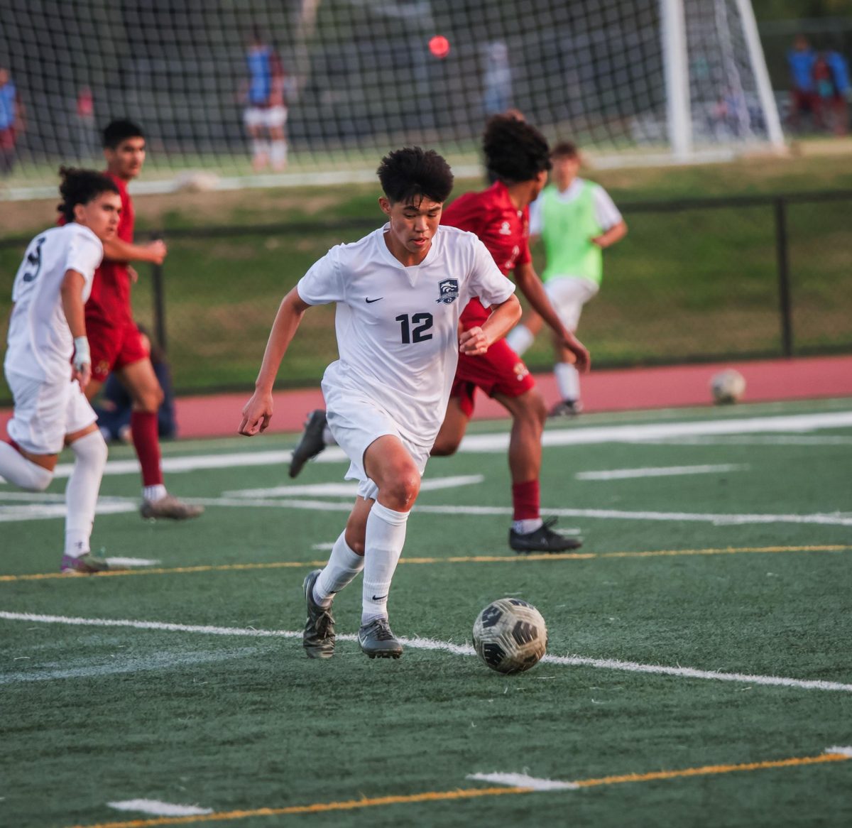 SHINING BRIGHT: Senior Ryan Loo charges downfield in varsity boys soccer’s pre-season win.