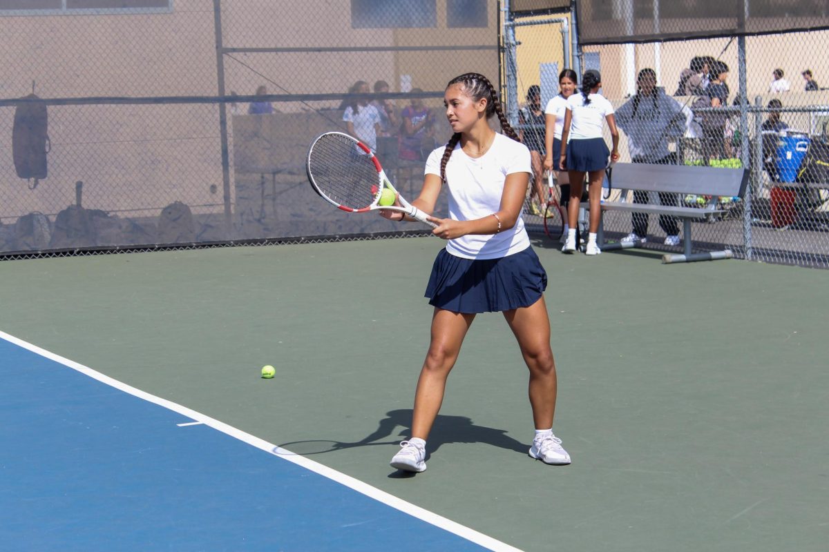 SERVING: Junior Yasmine Anan prepares to serve at the baseline.