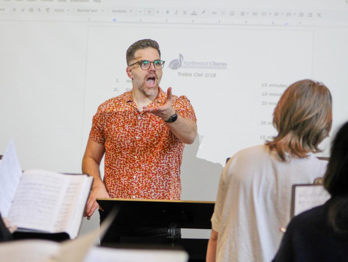 SHAPING VOICES: Choir director Tyler Alessi heads Treble Clef, vocally guiding his students through Cantate Domino.
