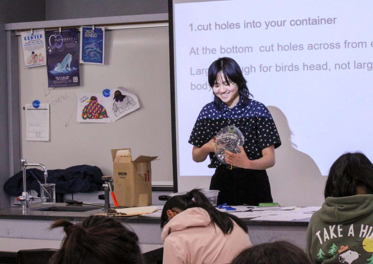 FEEDERS FOR FEATHERED FRIENDS: Junior Yun Wen, president of the bird club, presents slides on how to create DIY bird feeders from scrap plastic containers.
